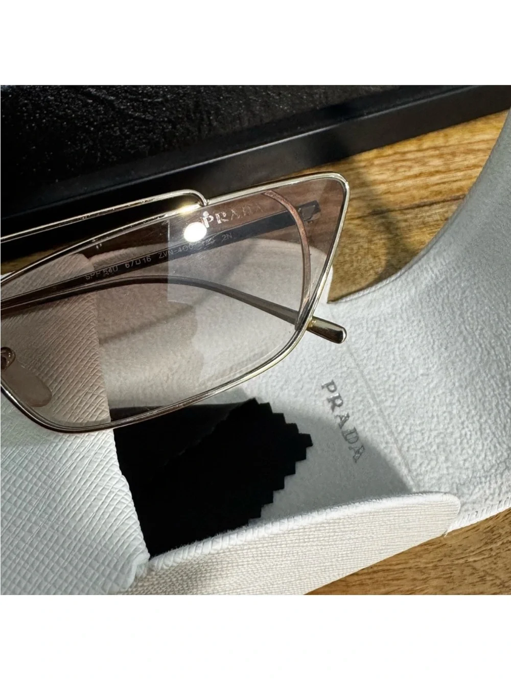 Prada Silver Frame Sunglasses with Gray Lenses